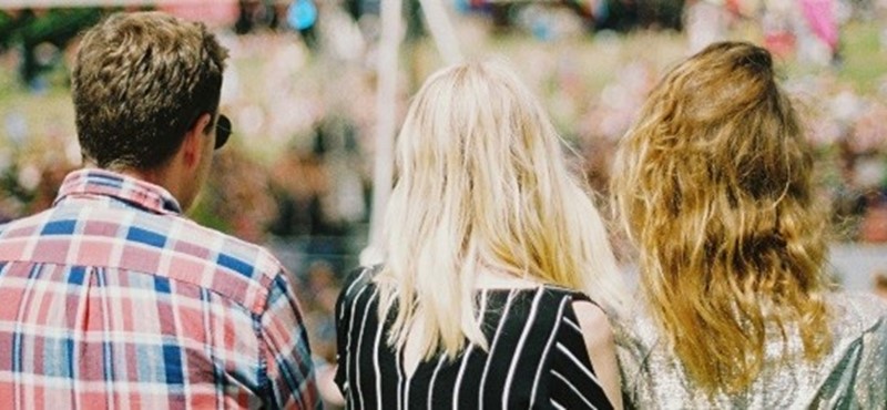 Photo of three people at a festival.