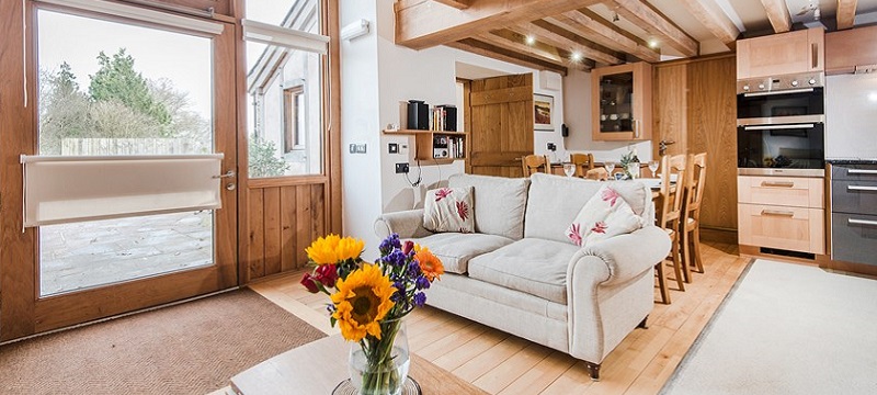 Photo of the sitting room and kitchen inside Thatch Close Cottages.