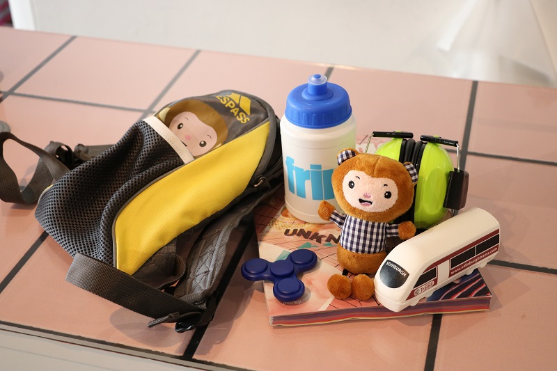 Photo of a Fringe sensory backpack including water bottle and fidget spinner.