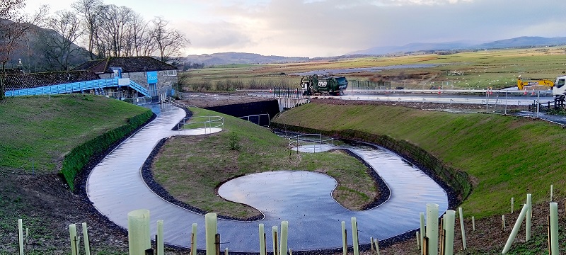 Photo of the new underpass and winding ramp down to it.