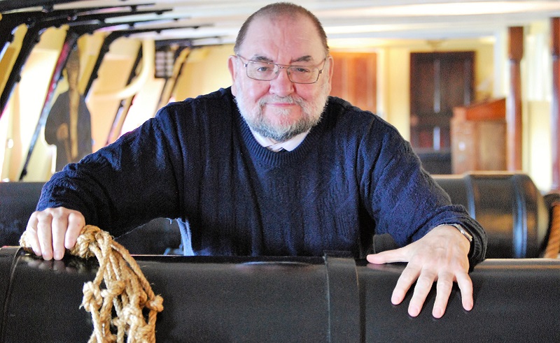 Photo of Bob holding a piece of rope from the tactile objects collection.