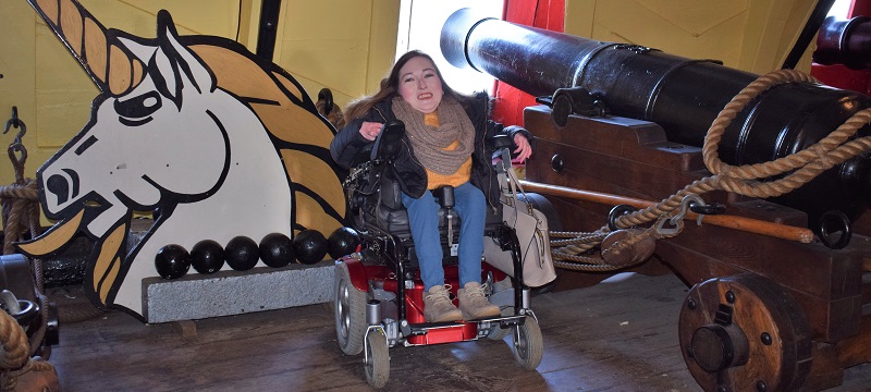 Photo of Claire beside a canon inside HMS Unicorn.