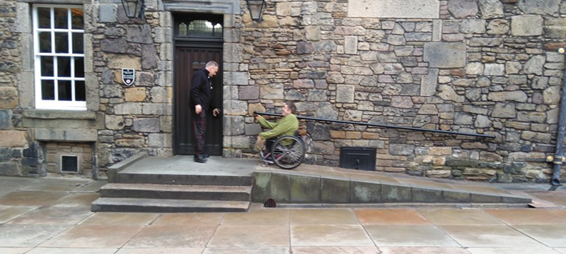 Image of wheelchair user going up a ramp at Edinburgh Castle