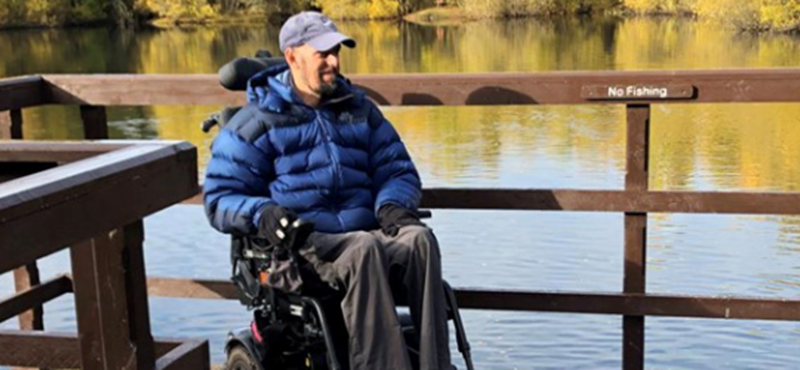 A powerchair user on a platform at Doune Ponds