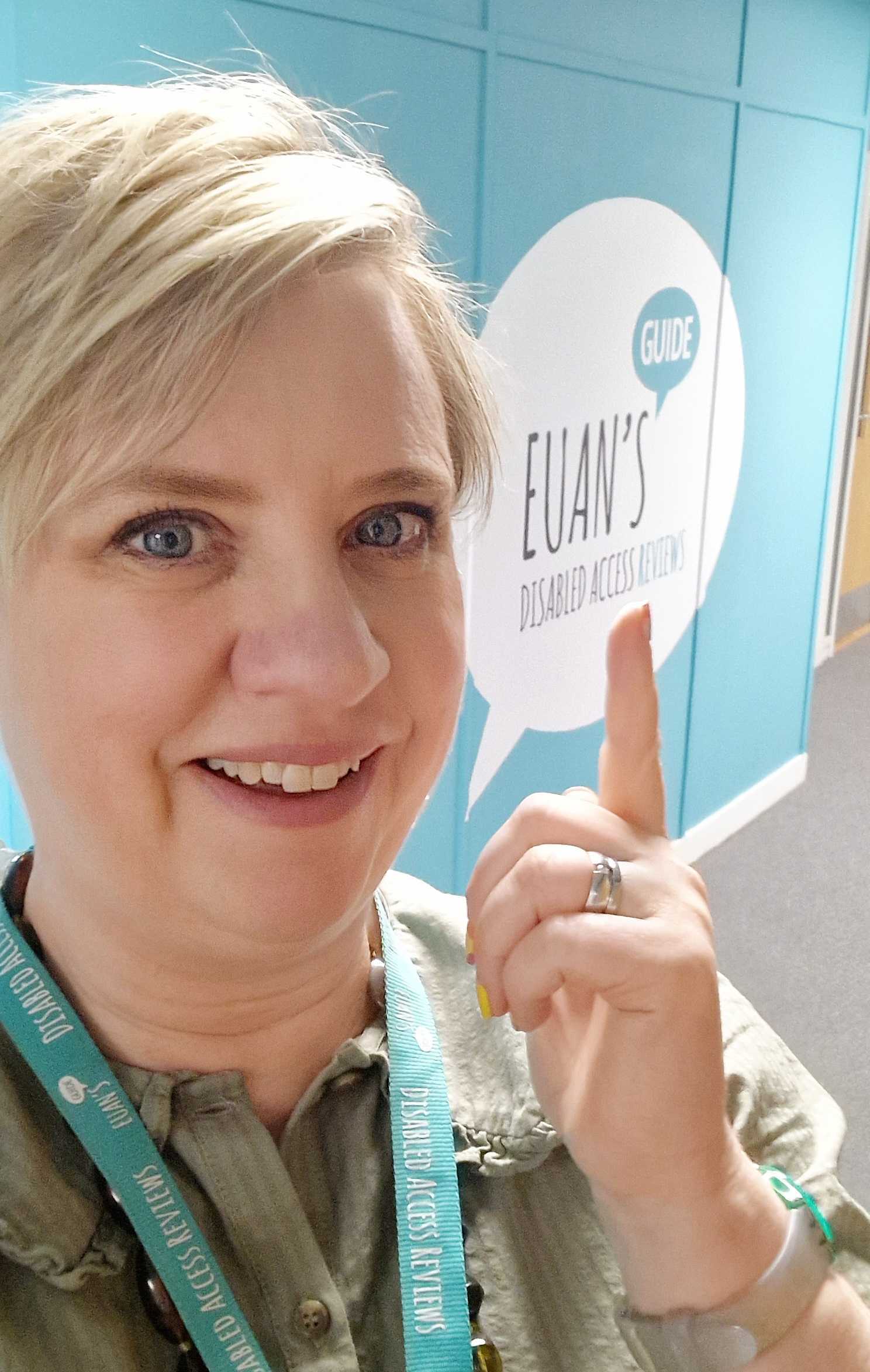 A selfie of Julie in front of a Euan's Guide branded wall