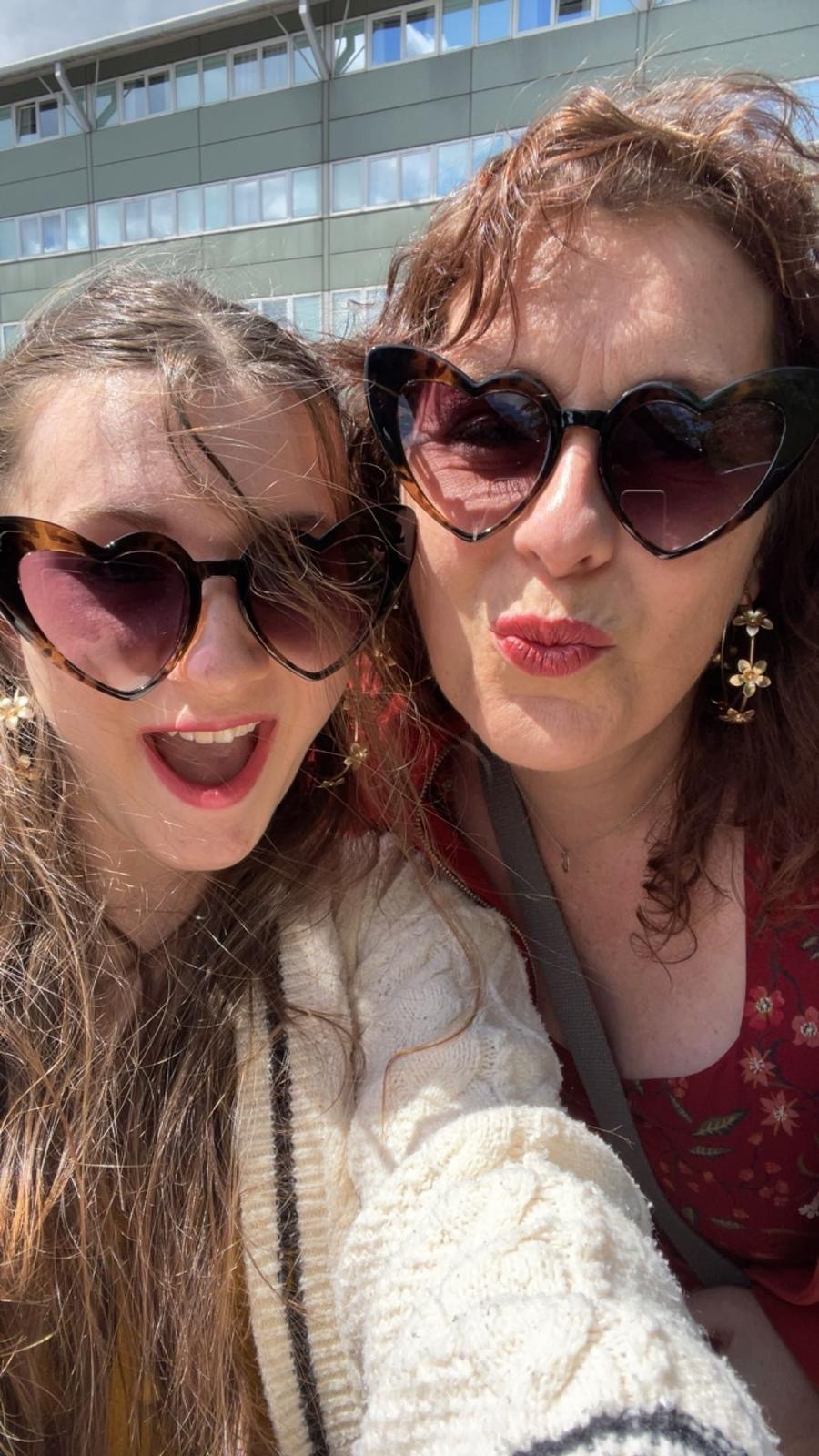 A selfie of Laura and her daughter wearing heart sunglasses