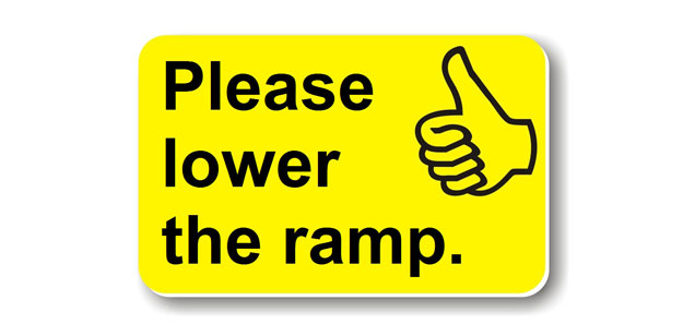 A photo of a card which says 'please lower the ramp'.