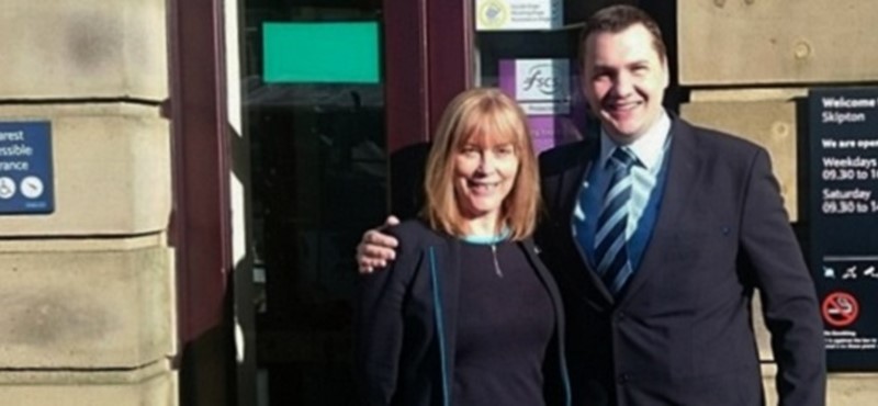 Photo of staff members outside a Barclays bank.