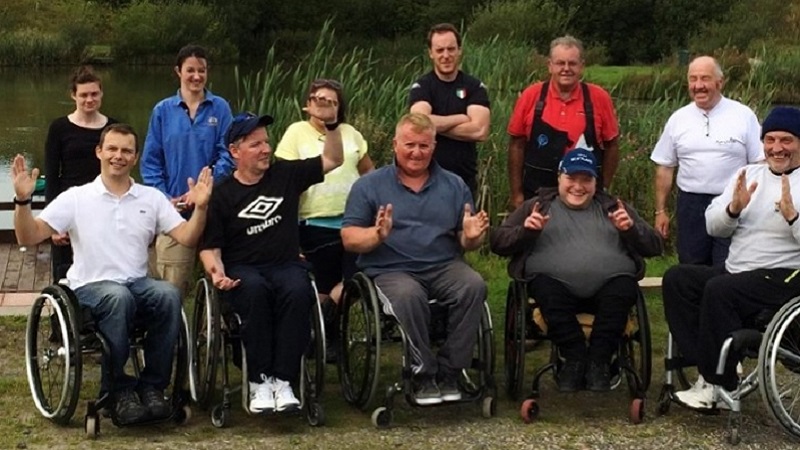 Photo of wheelchair users on a fishing trip.