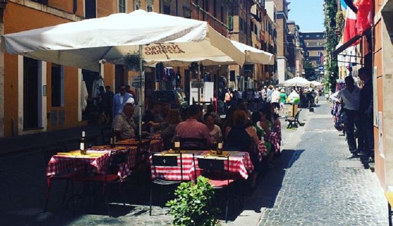 Image of people eating outside in a cafe.