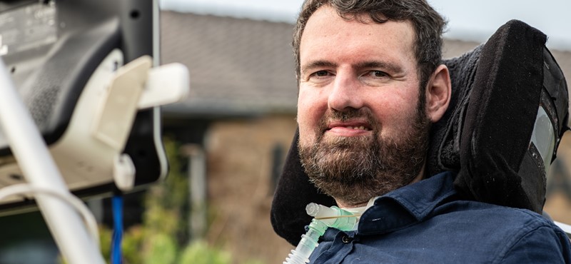 A photograph of Euan Macdonald smiling to camera.