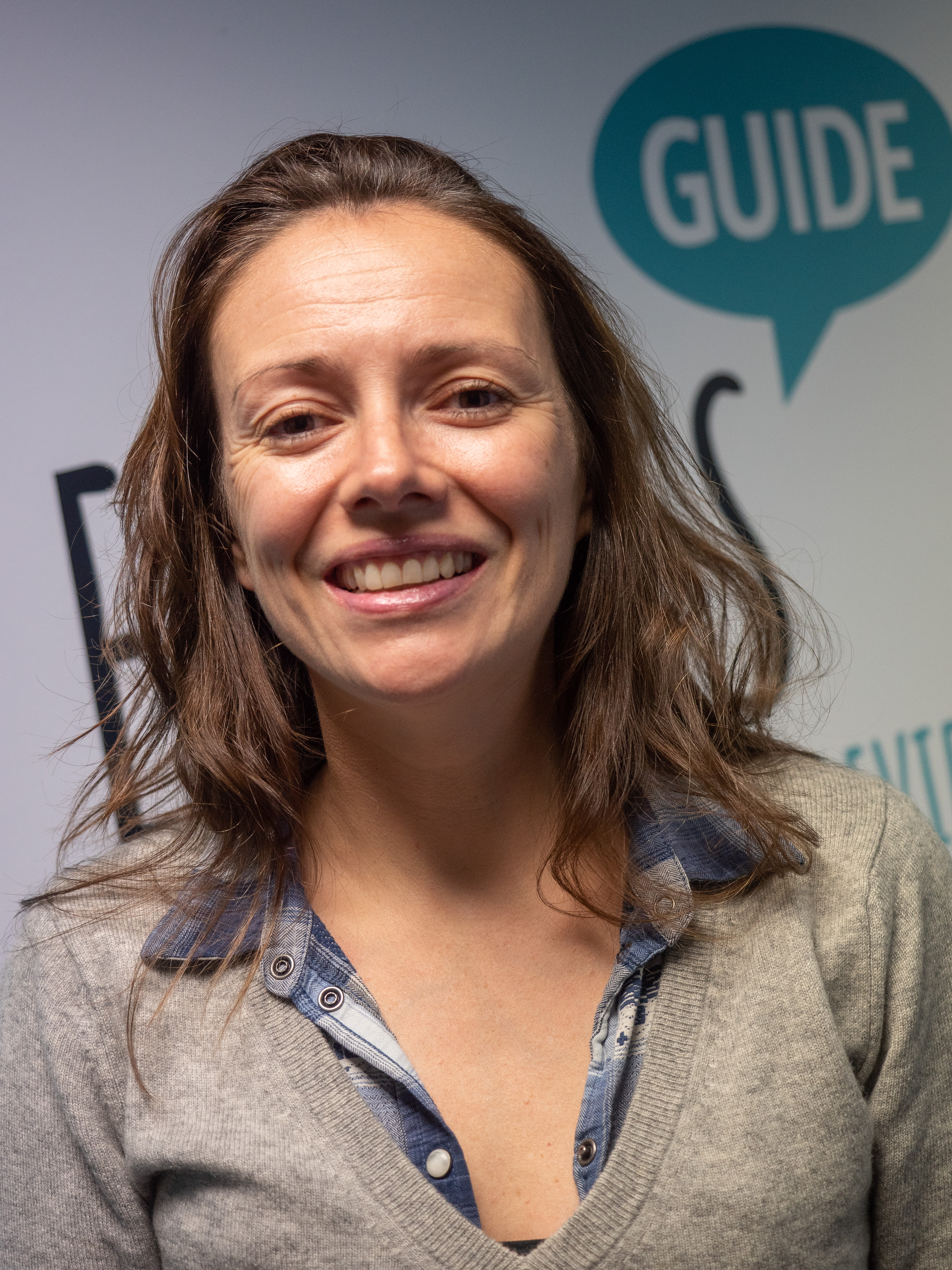 A photo of Antonia in front of Euan's Guide branding