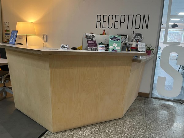 Wooden reception table, quite high.