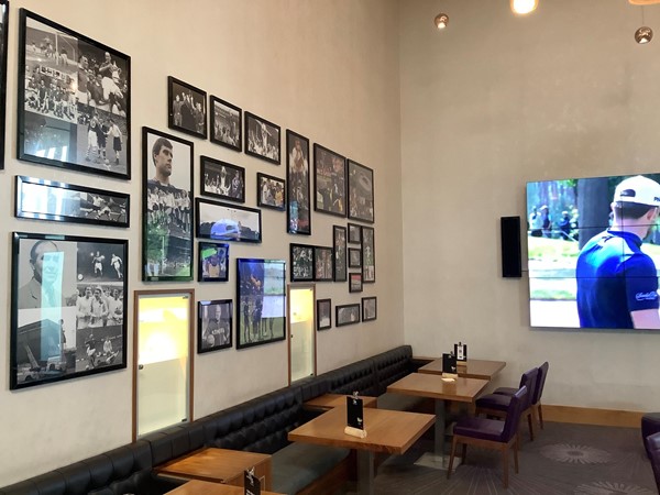 Picture of the seating area with football pictures on the wall