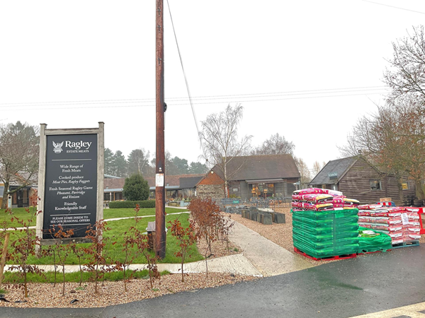 A path leads towards a number of well maintained huts, containing various  sections