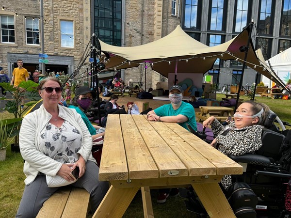 A picnic table with two wheelchair spaces so I can spend time with friends