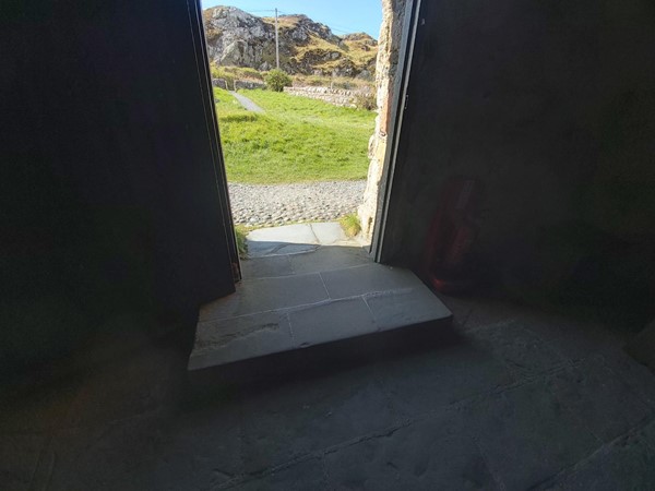 Image of small step leading into the chapel from the doorway.