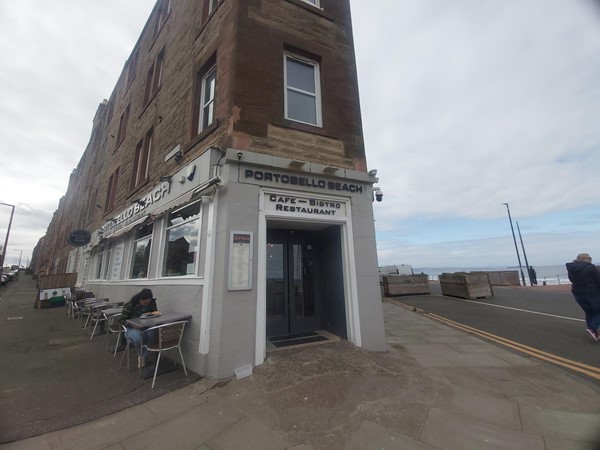 Image of a building with tables outside