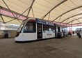 Image of a tram on the walkway at the airport.