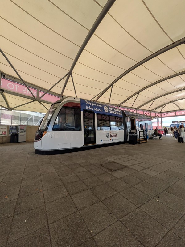 Image of a tram on the walkway at the airport.