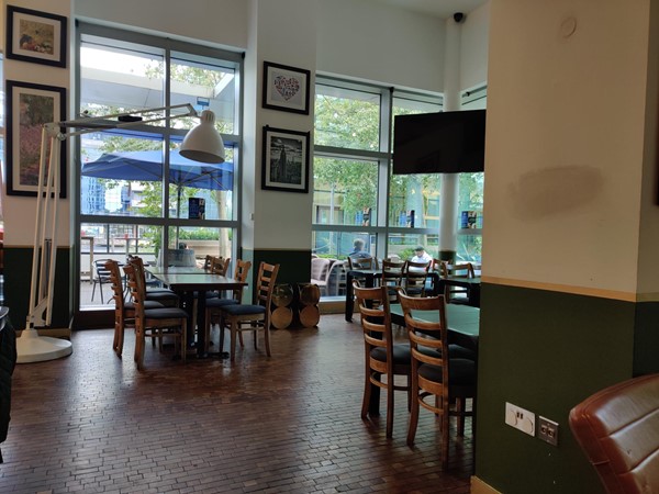 Part of the interior of the restaurant - tables, chairs, windows, a gigantic anglepoise lamp