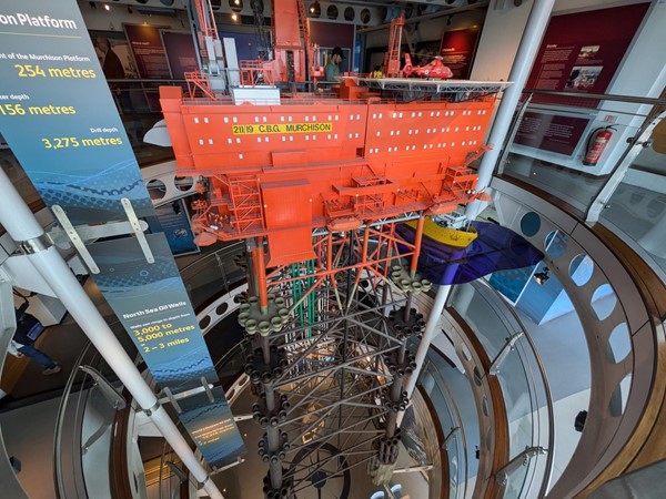 A scale model of an oil rig over the four floors of the museum