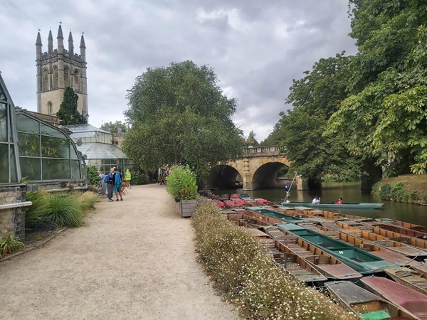 Punts on river, path , greenhouse and church