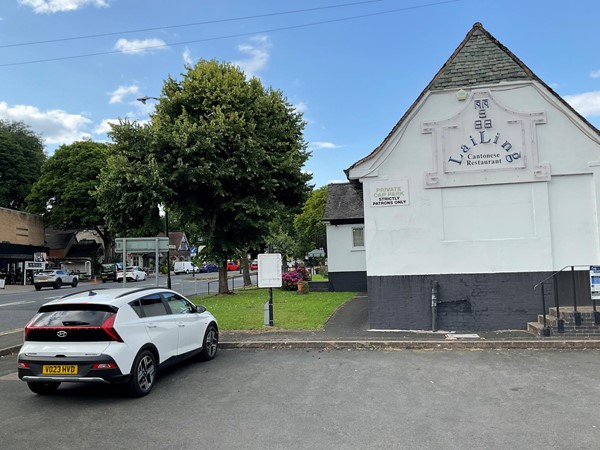 Image of a car parked in front of a building