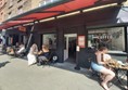 Image of a group of people sitting outside a cafe