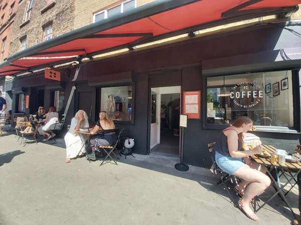 Image of a group of people sitting outside a cafe