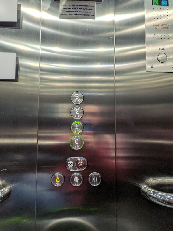 Image of the lift buttons, each button has Braille markings