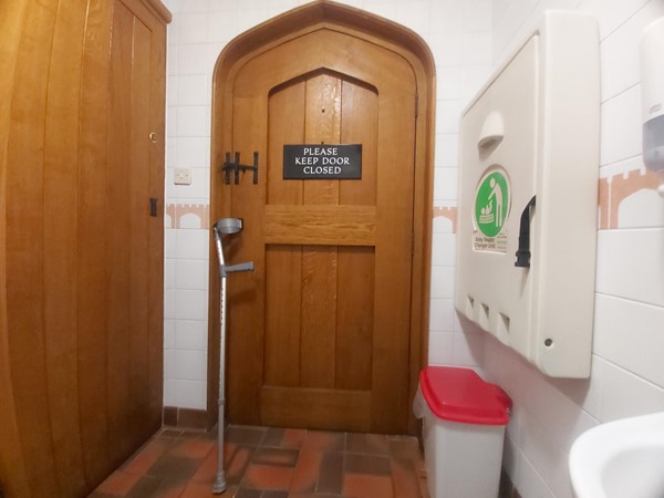 Image of a wooden door and a walking aid