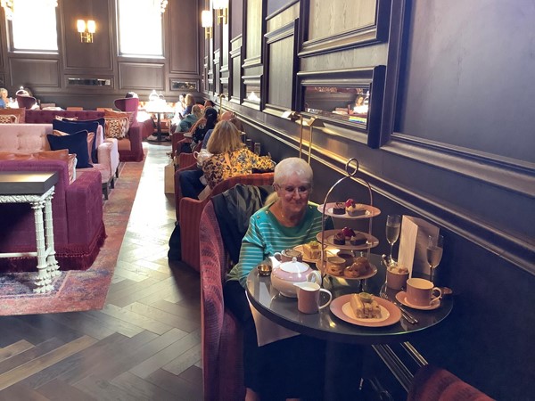 A person having afternoon tea at a table