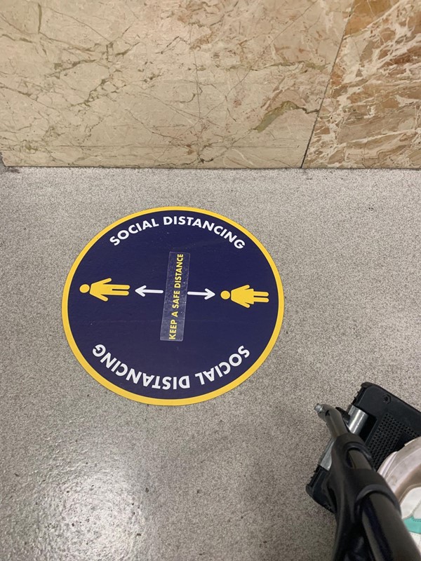 Social distancing sticker on station floor