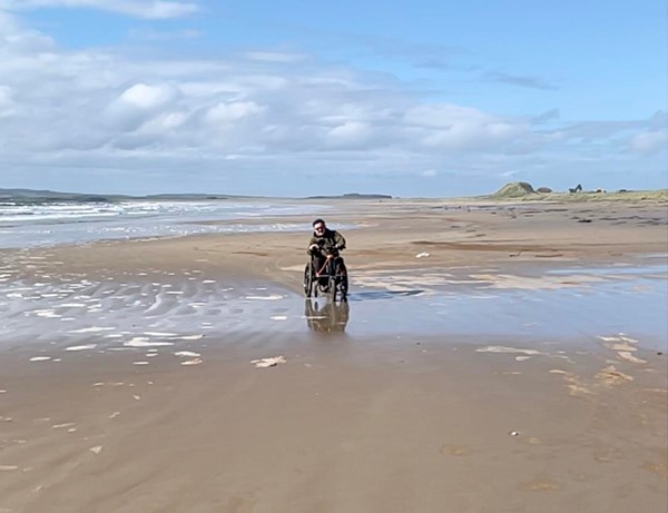 Image of a person in a wheelchair on a beach