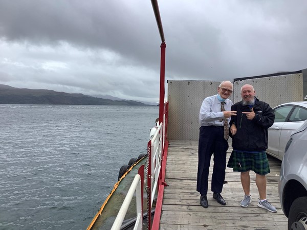 Two people pointing at each other on a ferry