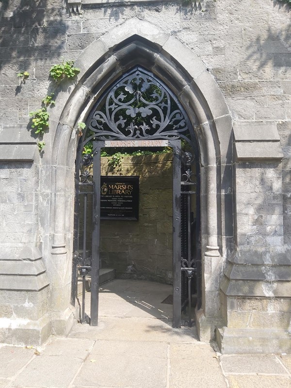 Image of a stone archway with a black gate