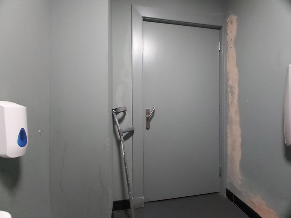 Image of the door leading out of the accessible toilet.