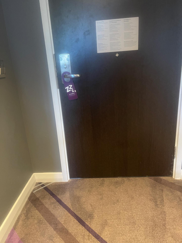 The photo shows a small corridor leading to the bedroom door which is a heavy wooden door which opens in the way so it makes it difficult to open from a wheelchair.