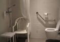 bathroom with bath stool and requested chair with arms