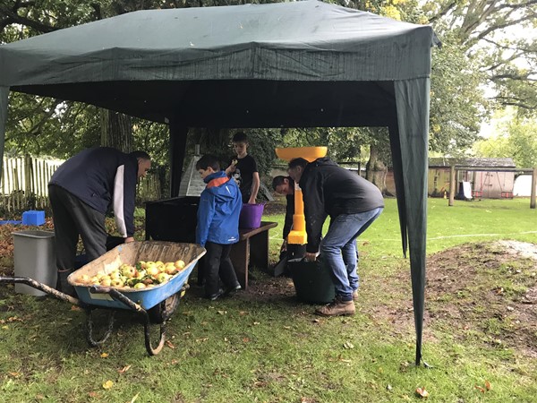 Image of people in the grounds outside the village hall.