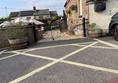 Image of a gated driveway with a fence and plants