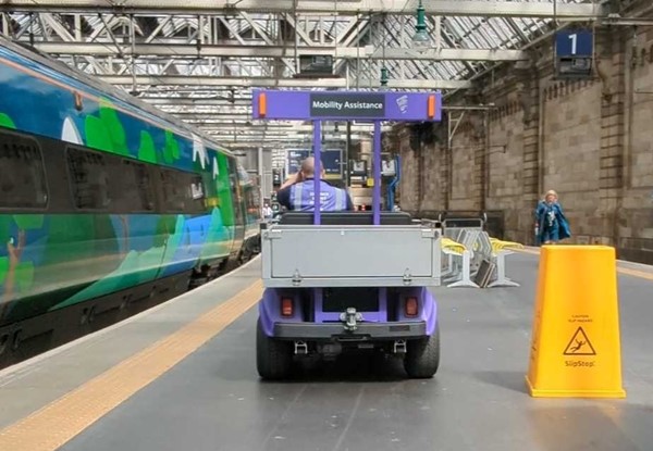 A person driving a vehicle at a train station