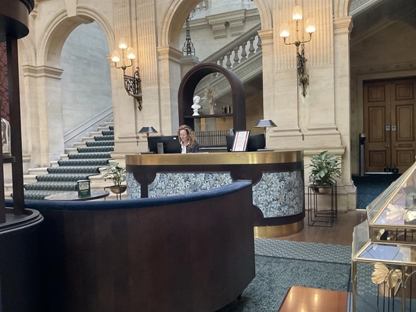 Image of a person at a reception desk in a building