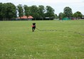 Large field with cafe building in the background.