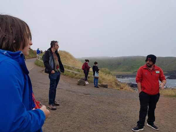 National Trust guide telling local stories on the road down to the rocks of the Giant's Causeway