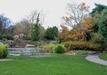 Gardens and lake with concrete path around them.