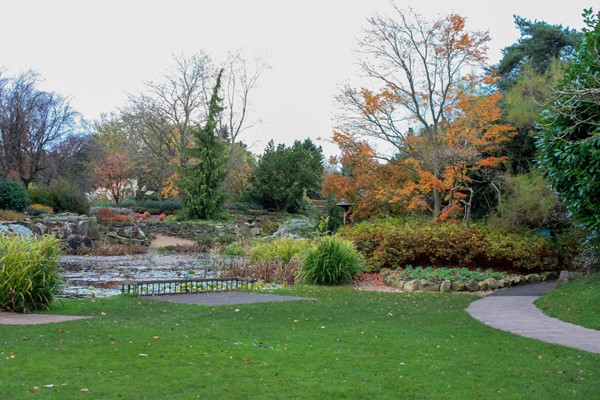 Gardens and lake with concrete path around them.