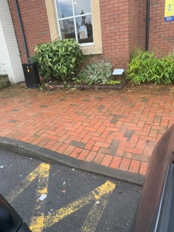 View of kerb next to blue badge parking