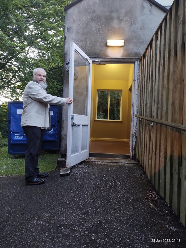 Picture of a man holding a door open